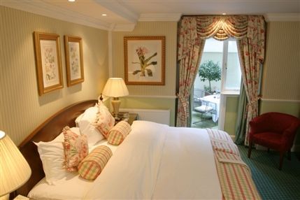 The Academy Hotel London - The Garden Suite with doors leading to a private garden